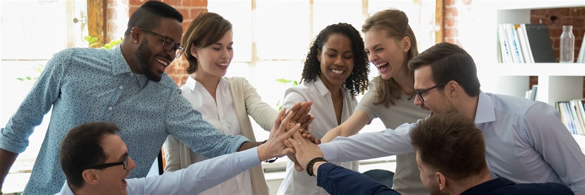 Group of people with hands in the center