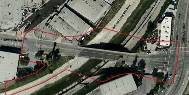 Photograph of ariel view of Higuera St bridge and surrounding buildings and intersecting streets Jefferson Blvd and Eastham Dr, as well as Ballona Creek below, 2021