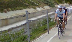 Photograph of two bicyclists riding along the Ballona Creek Bike Path