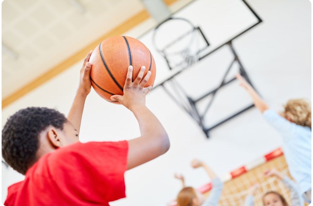 Boy shooting basketball