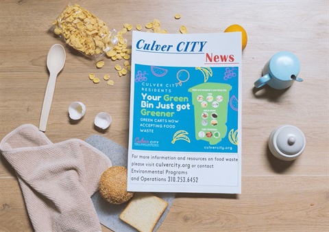 Top-down view of desk scene with Culver City news publication